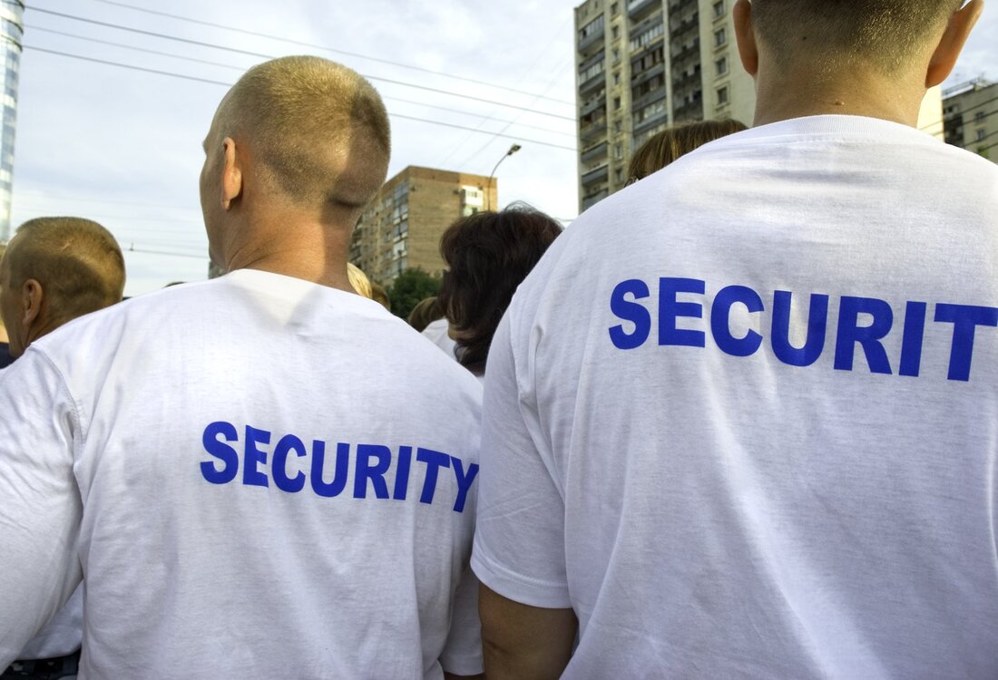 two people wearing security shirt